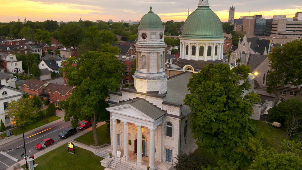 Aerial view of a green domed building in a residential neighbourhood.