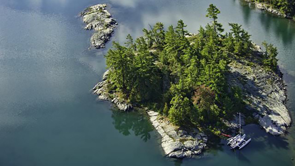 Aerial view of a small rocky island in a lake.