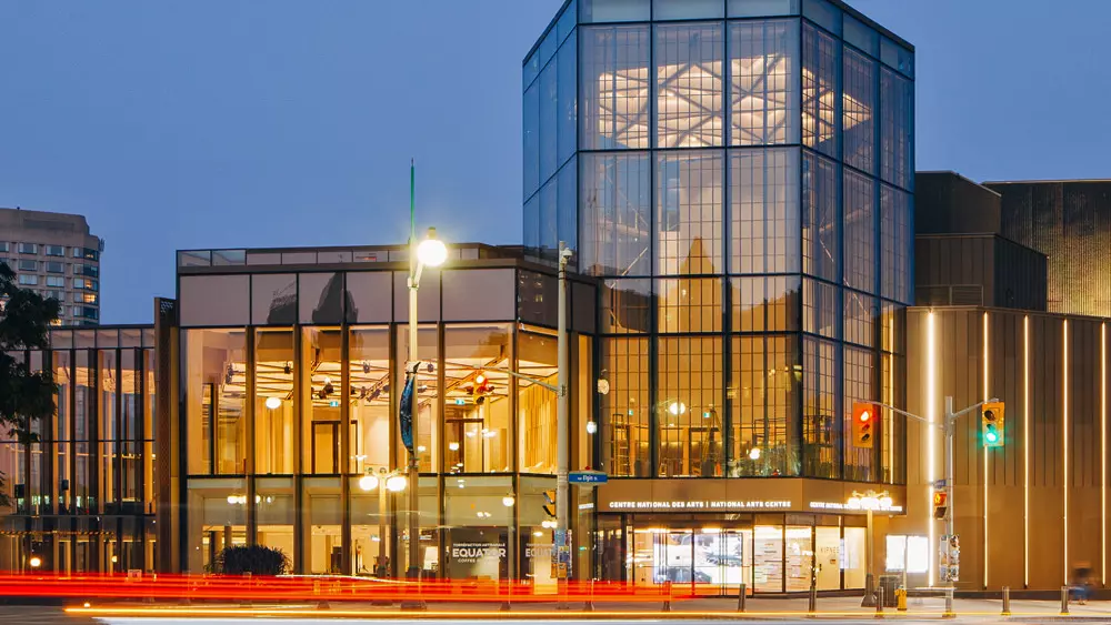 The National Arts Centre in Ottawa lit up at night.