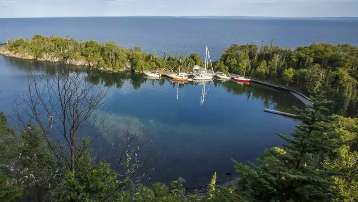 Several boats and sailboats in a beautiful bay on Lake Superior.