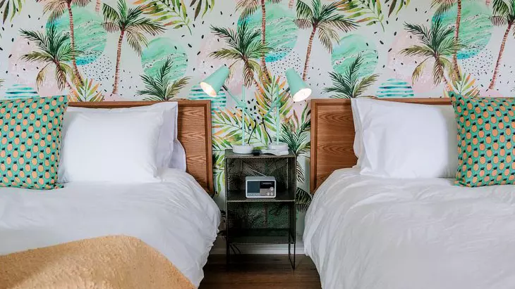 Two empty beds in a charming hotel room