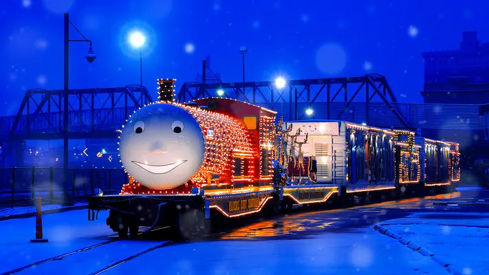 先頭に笑顔を描いた列車が、休日に合わせて装飾され、夜にはライトアップされます。