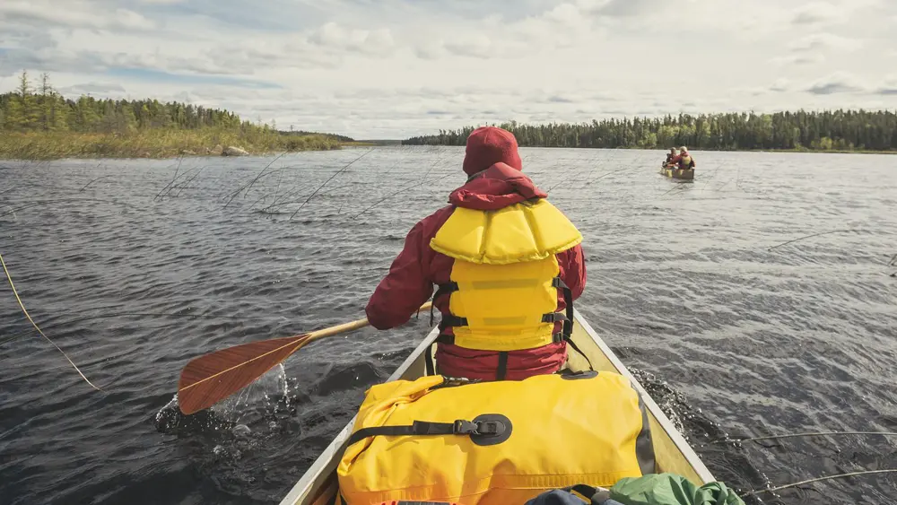 Two canoes with camping gear set out on a paddling trip in Wabakimi Provincial Park.