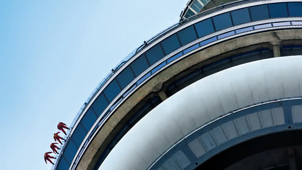 Vier Personen sind bei der EdgeWalk-Tour am äußeren Rand des CN Tower in Toronto befestigt.
