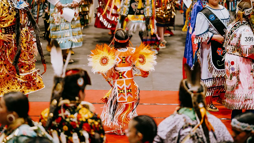 Dancers in regalia participating in an Indigenous pow wow in Sault Ste. Marie.