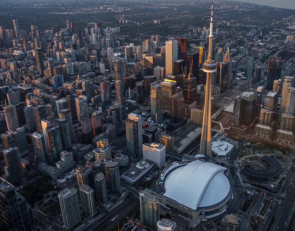 Aerial view of downtown Toronto, surrounded by tall office buildings, including the CN Tower and the Rogers Centre