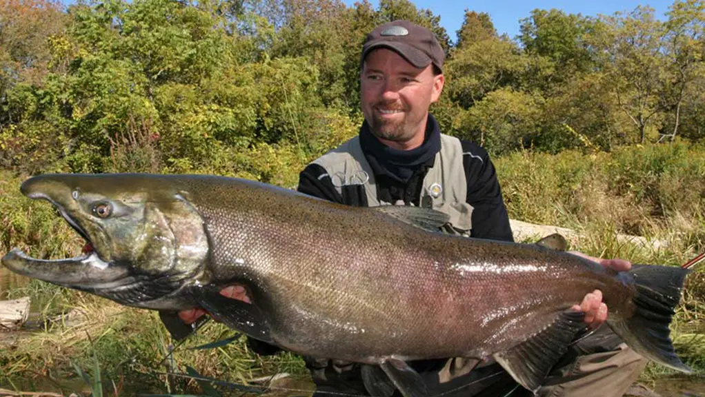 Angler, Glen Hales holds up a record-sized 29 pound coho salmon.