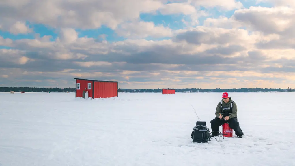 Un homme pêchant sur la glace sur le lac Nipissing.