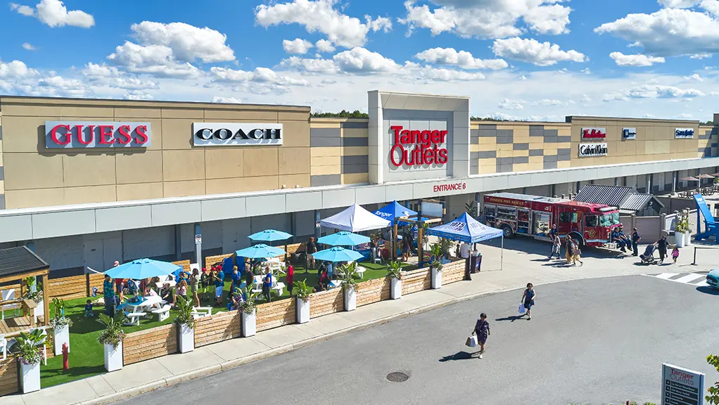 Exterior of Tanger Outlet mall on a sunny day.