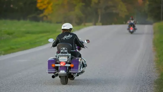 Two motorcyclists riding on an open road