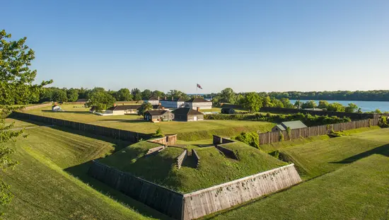 Northfacing view of lawn and buildings of Fort George with Niagara River beyond