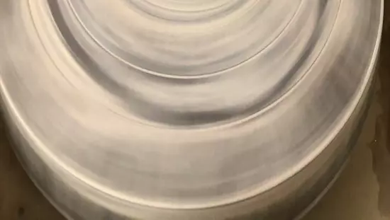 Close-up of a woman sculpting a vase at a sculpting table