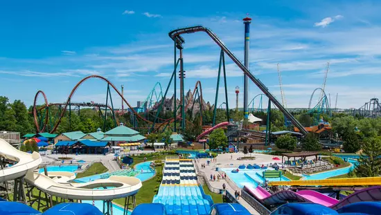 An amusement park filled with water slides, roller coasters and free fall rides.