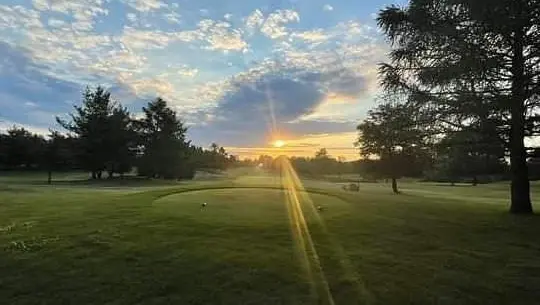 Blue skies as the sun is rising over the golf course