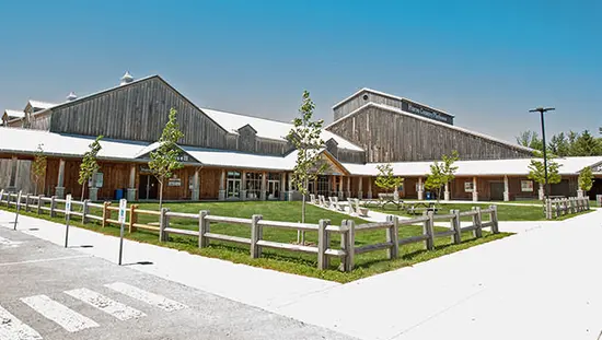 A large building with wooden fencing
