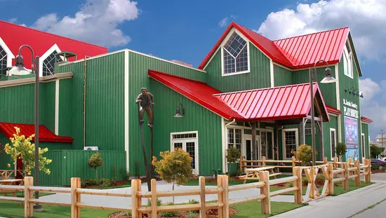A sculpture and a picnic table in front of a large theatre