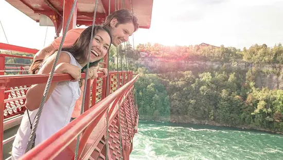 Two people in the aero car looking down at the Niagara Whirlpool