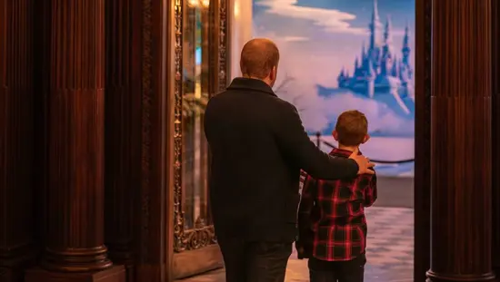 A father and young son view a fantasy exhibit in one of the grand rooms at Toronto's Casa Loma.