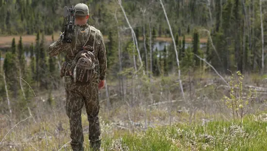 A man wearing camouflage attire on a bow hunting trip in Algoma Country.