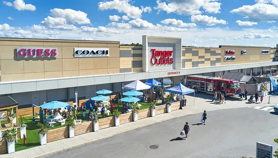Exterior of Tanger Outlet mall on a sunny day.