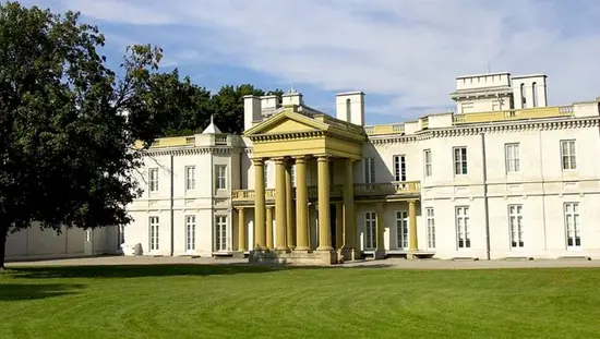 A view of the formal entrance of a historic mansion.