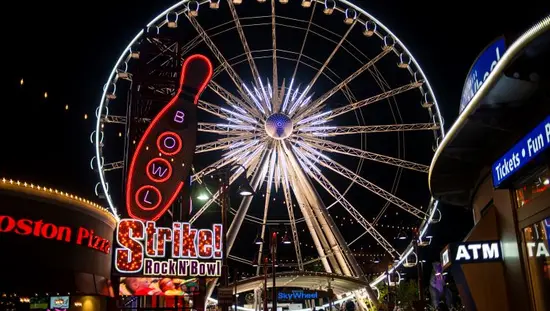 A ferris wheel with lights at night.