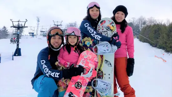 스노보더 가족이 카메라에 포즈를 취하고 있습니다.