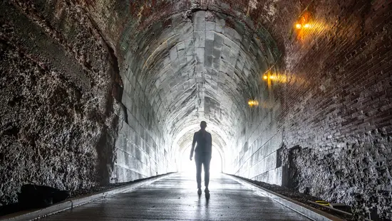 A person walking in a tunnel