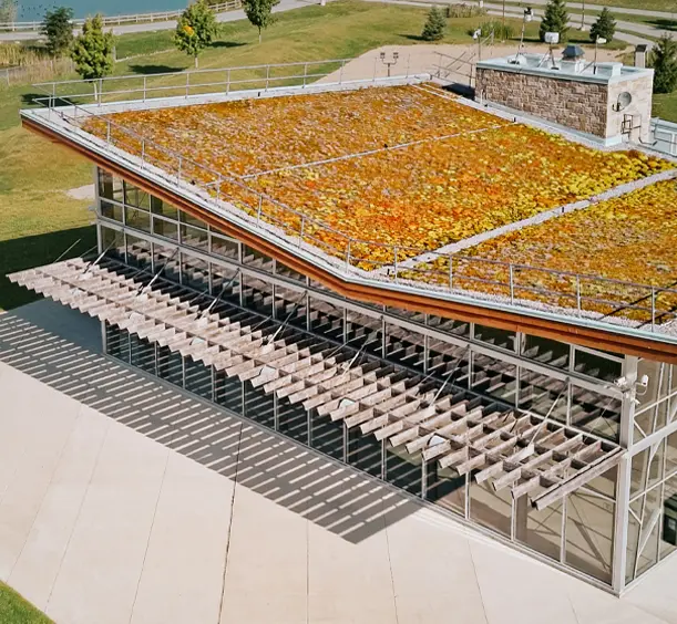 Aerial view of The ROC in Georgina, Ontario, showing the modern facility with a living roof surrounded by green fields and ponds.