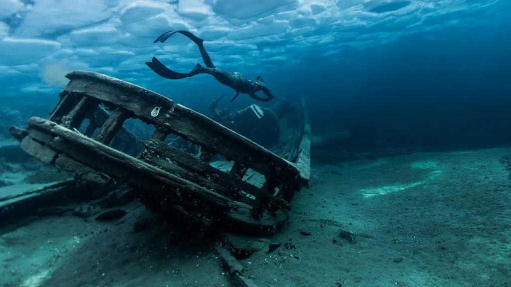 A person scuba dives around an underwater wreck in Ontario.