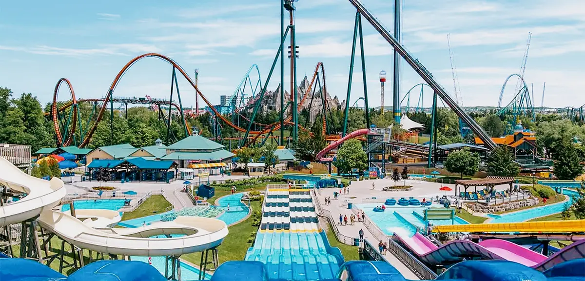 A lively amusement park with water slides, roller coasters and a drop tower under a sunny sky at Canada's Wonderland, Vaughan.