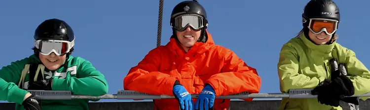 Three downhill skiers ride a ski lift at Mount. St. Louis Moonstone.