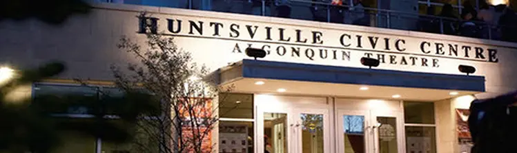 Front doors of the Algonquin Theatre lit up at night.