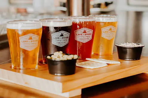 A beer flight containing four varierties of beer and accompaniments from the Lake of the Woods Brewing Company.