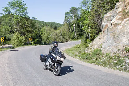 Eine Person auf einem Motorrad, die auf einer kurvigen Straße fährt