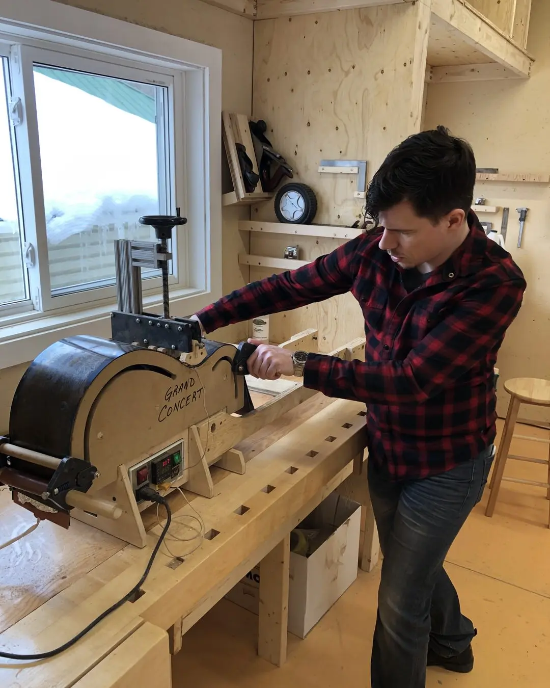 A man handcrafting an acoustic guitar