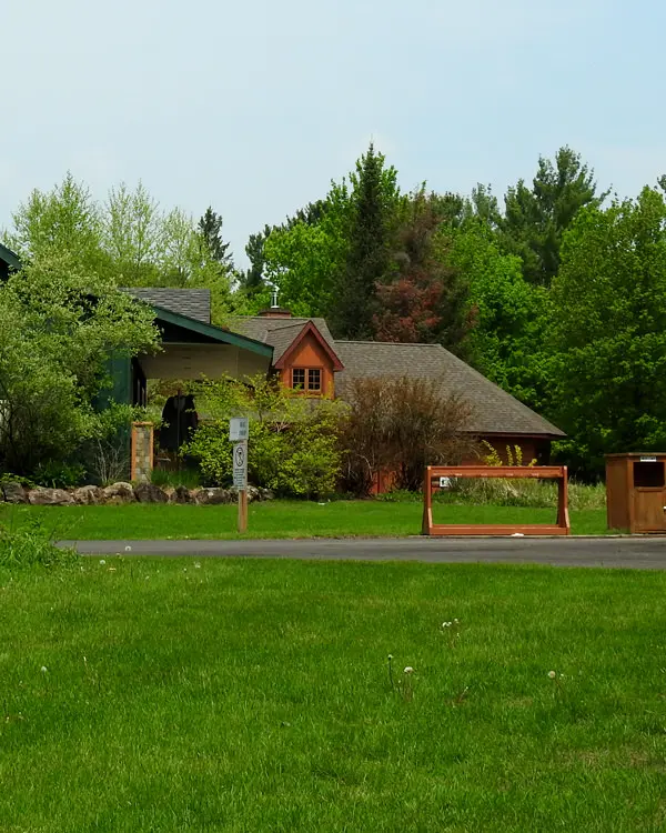 Manicured green lawns and forest surround the main golf lodge