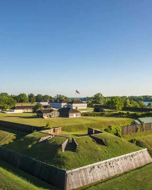 Northfacing view of lawn and buildings of Fort George with Niagara River beyond