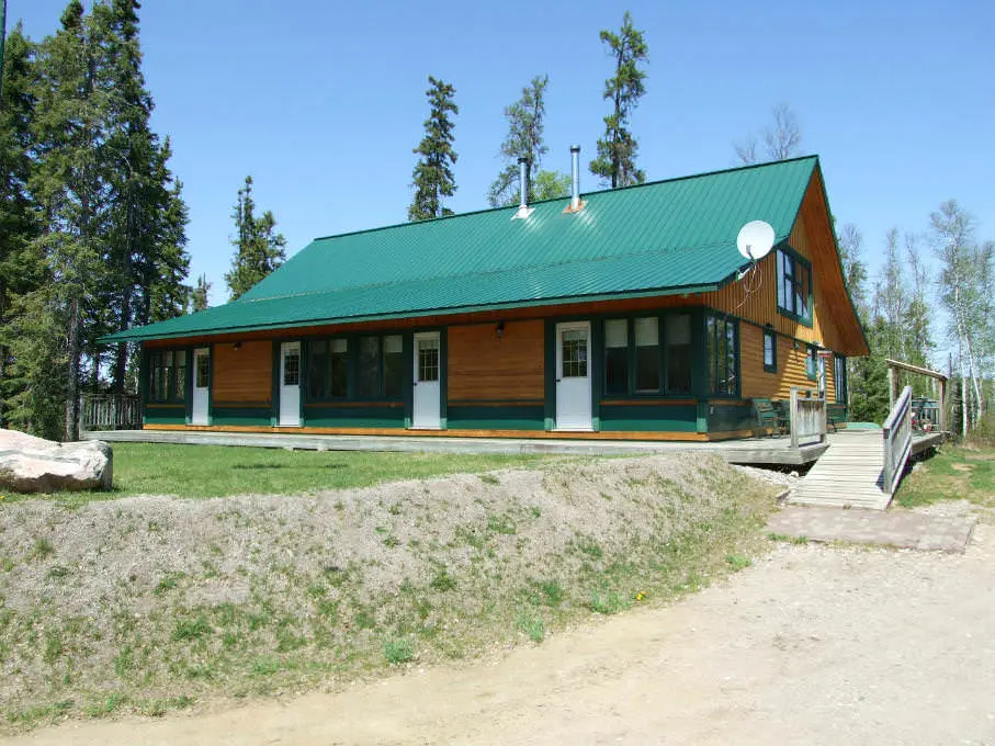 A wooden  building at the top of a small hill
