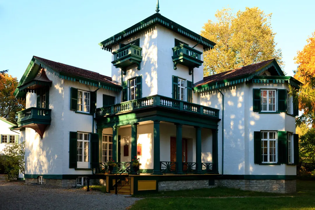 Exterior of historic white and green home