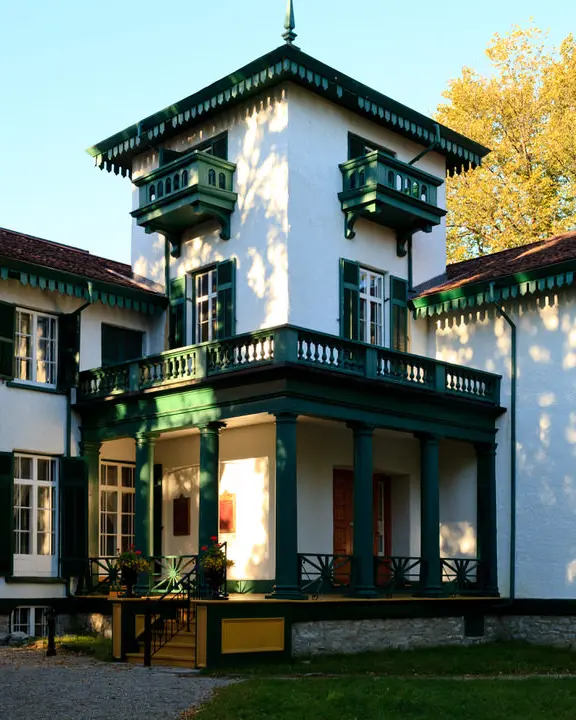 Exterior of historic white and green home