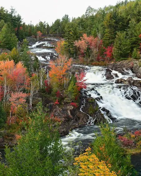 Waterfall surrounded by fall foliage