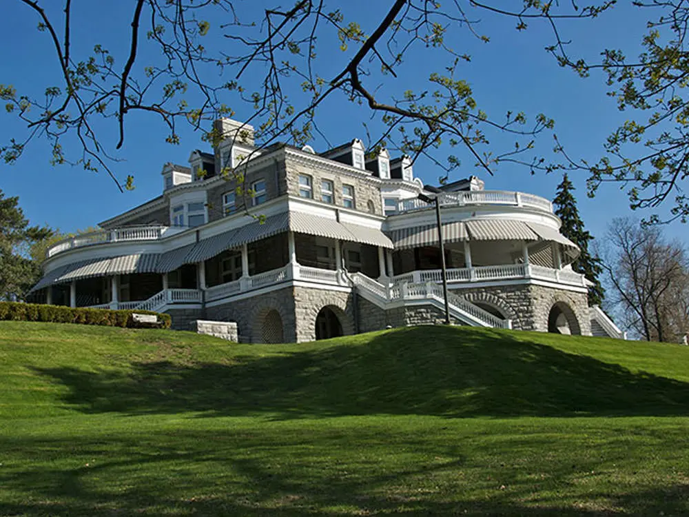 A stunning white mansion on a hill