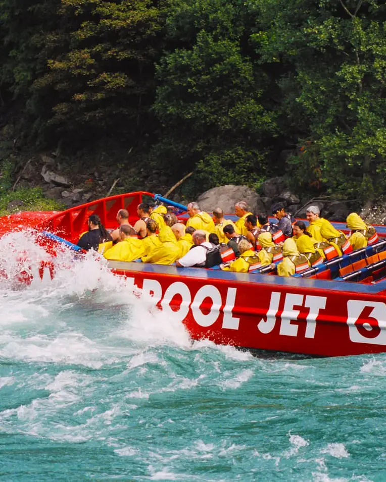 A jet boat in rough waters navigating through a gorge