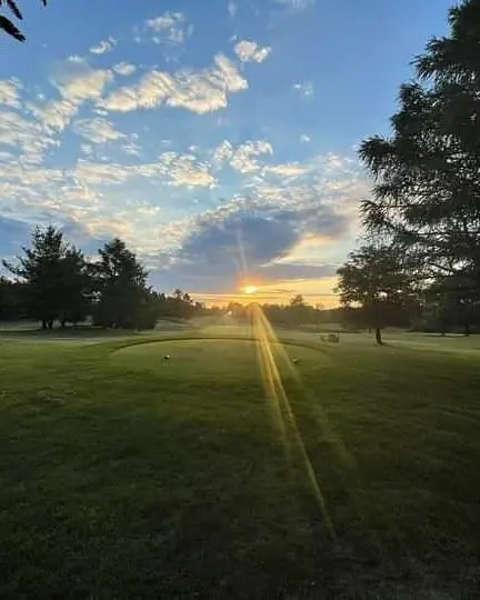 Blue skies as the sun is rising over the golf course