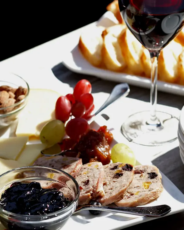 Une charcuterie, un verre à vin et des assiettes