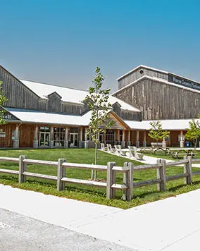 A large building with wooden fencing