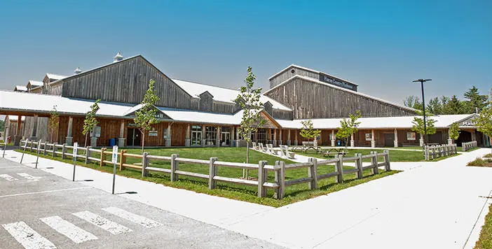 A large building with wooden fencing