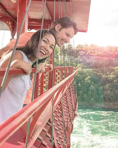 Two people in the aero car looking down at the Niagara Whirlpool