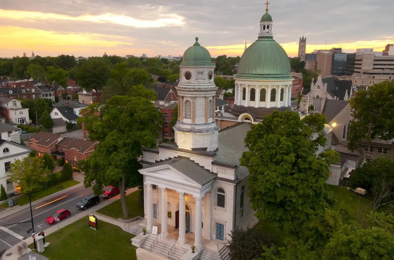 Aerial view of a green domed building in a residential neighbourhood.